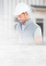 Construction Worker with pen chart in front of construction site with transition effect Royalty Free Stock Photo