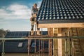Construction Worker Performing Roof Installation