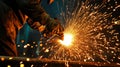 Construction worker performing welding tasks at a job site for building project completion Royalty Free Stock Photo