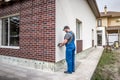 Construction worker plaster the facade of the house. Application Of Facade Plaster Royalty Free Stock Photo