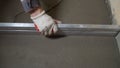 Construction worker plastering on gypsum walls. Builder spreading plaster on aerated concrete block wall with Royalty Free Stock Photo
