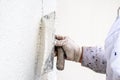 Construction worker plastering and smoothing concrete wall with cement Royalty Free Stock Photo