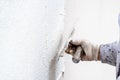 Construction worker plastering and smoothing concrete wall with cement Royalty Free Stock Photo