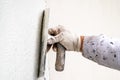 Construction worker plastering and smoothing concrete wall with cement Royalty Free Stock Photo