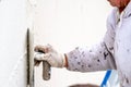 Construction worker plastering and smoothing concrete wall with cement Royalty Free Stock Photo