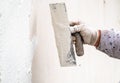 Construction worker plastering and smoothing concrete wall with cement Royalty Free Stock Photo