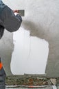 Construction worker - plastering and smoothing concrete wall wit Royalty Free Stock Photo