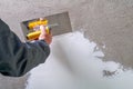 Construction worker - plastering and smoothing concrete wall wit Royalty Free Stock Photo