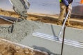 Construction worker pour cement for sidewalk in concrete works with mixer truck with wheelbarrow