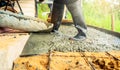 Construction worker pour wet concrete at construction site. Construction worker working with ready-mix concrete pouring from Royalty Free Stock Photo