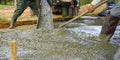 Construction worker pour wet concrete at construction site. Construction worker working with ready-mix concrete pouring from Royalty Free Stock Photo