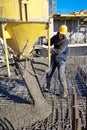 Construction worker pouring concrete