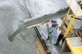 Construction worker pouring concrete from cement truck, people worker Royalty Free Stock Photo