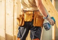 Construction Worker Prepares Tools in Wood-Framed Building Site Royalty Free Stock Photo