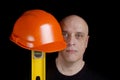 Construction worker with protection helmet and level