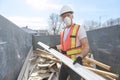Construction Worker outside of house put old renovation material on big conteiner Royalty Free Stock Photo