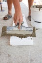 Construction worker puts a gypsum on styrofoam with spatula. Royalty Free Stock Photo