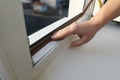 Construction worker putting sealing foam tape on window, closeup Royalty Free Stock Photo