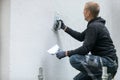 Construction worker putting decorative plaster on house exterior Royalty Free Stock Photo