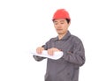 Construction worker in red hard hat rolls up drawings Royalty Free Stock Photo