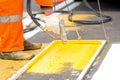 Construction worker remarking pedestrian crossing lines Royalty Free Stock Photo