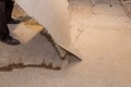 Construction worker remove old laminate floor for repairing and installing parquet in house