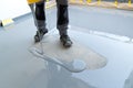 Construction worker renovates balcony floor and pours watertight resin and glue before chipping and sealing Royalty Free Stock Photo