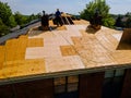 Construction worker on renovation roof the house installed new shingles Royalty Free Stock Photo