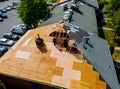 Construction worker on renovation roof the house installed new shingles Royalty Free Stock Photo