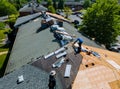 Construction worker on renovation roof the house installed new shingles Royalty Free Stock Photo