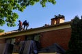 Construction worker on renovation roof the house installed new shingles Royalty Free Stock Photo