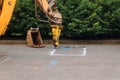 Construction worker repairing road with Jackhammer