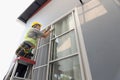 Construction worker repairing the sliding window. Open cap of adjust rail wheel Royalty Free Stock Photo