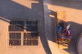 Construction worker resting in the shade and using his smartphone during a break in Bangkok, Thailand. Top down view. Royalty Free Stock Photo