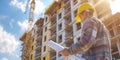 Construction Worker Examining Blueprints at a Building Site Royalty Free Stock Photo