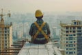 Construction Worker in Safety Gear Installing Roof Tiles with Precision and Care.