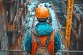 Construction worker in safety gear overseeing the site, back view Royalty Free Stock Photo