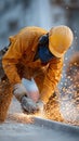 Construction worker in safety gear uses power tool, creating bright sparks Royalty Free Stock Photo