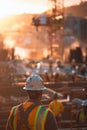 Construction worker in safety gear using power drill at construction site for building new structure Royalty Free Stock Photo