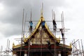 Worker on scaffolding working for repair and renovation roof of temple.