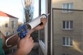 Construction worker sealing window with caulk indoors, closeup Royalty Free Stock Photo