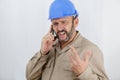 Construction worker shouting on phone Royalty Free Stock Photo