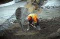 Construction worker shovel road repair drain sewer work excavation digger Royalty Free Stock Photo