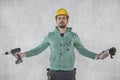 The construction worker shows the tools necessary for his work, front view Royalty Free Stock Photo