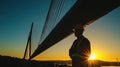 Construction Worker Silhouette Against a Sunset Behind a Modern Bridge Capturing the Essence of Engineering and Labor in Urban Royalty Free Stock Photo