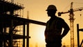 Construction worker silhouette sunset building site crane scaffolding industrial labor development Royalty Free Stock Photo