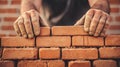 A construction worker skillfully lays bricks, creating a sturdy wall amidst a blurred backdrop of activity Royalty Free Stock Photo