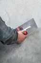 Construction worker smoothing - plastering concrete wall by a st Royalty Free Stock Photo