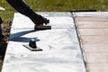 Construction Worker Smoothing Wet Cement With Hand Edger Tool