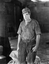 Construction worker standing near a wheelbarrow